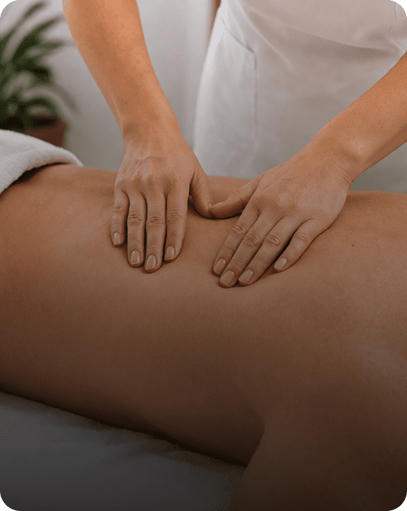 Massage therapist hands on client's bare back