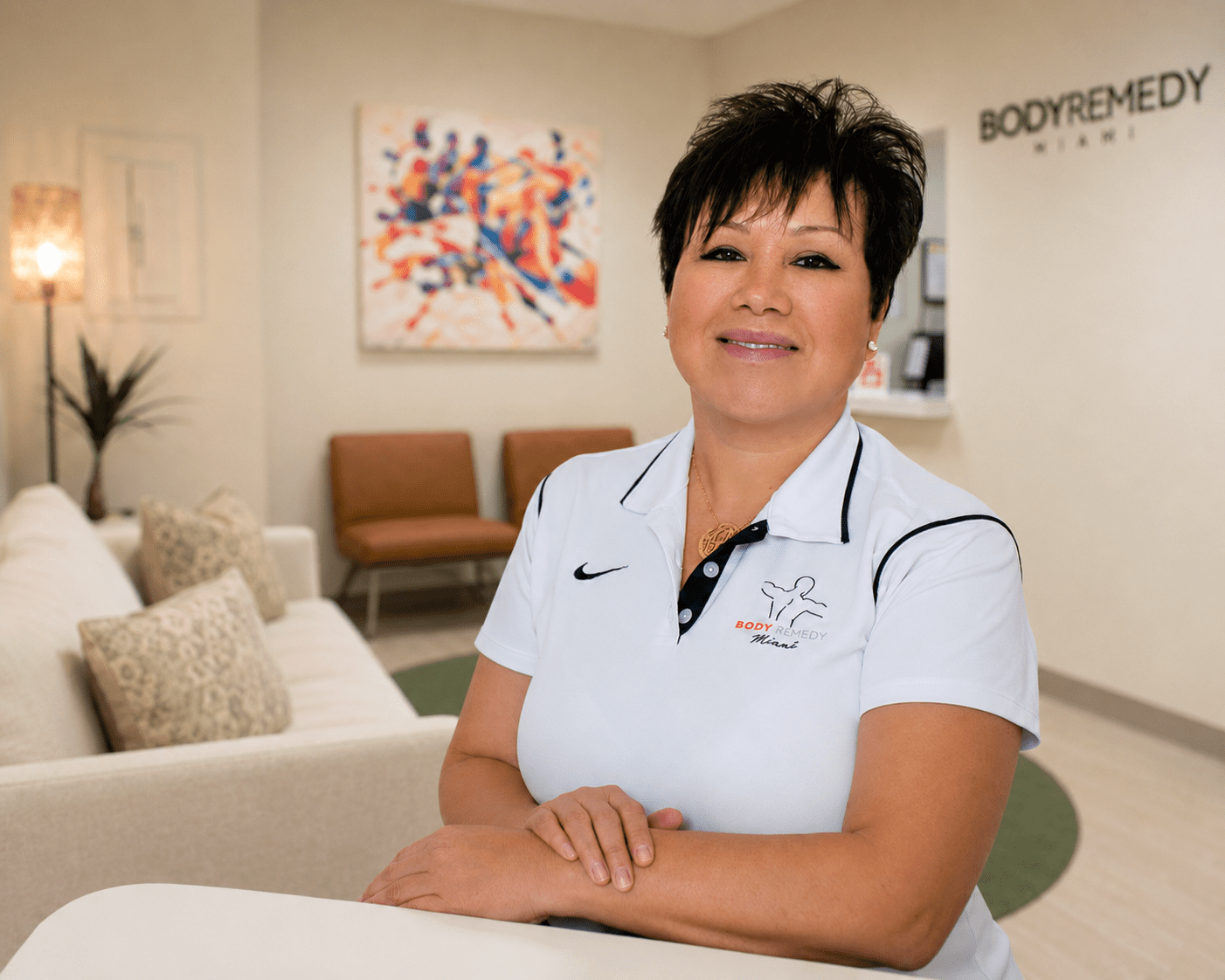 Smiling clinic receptionist in white polo